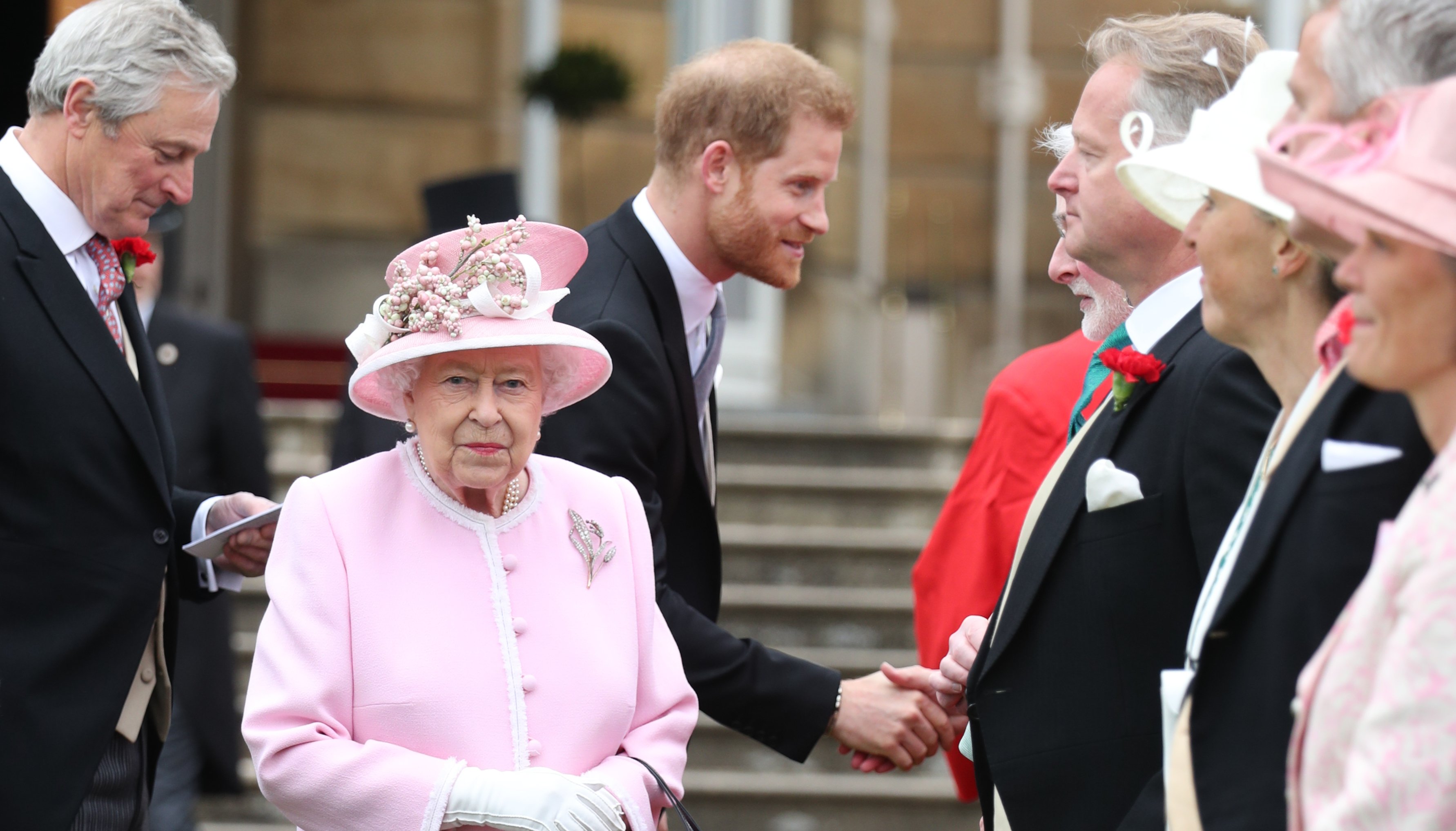 Queen Elizabeth II and the Duke of Sussex meet guests during a Royal Garden Party at Buckingham Palace in London.