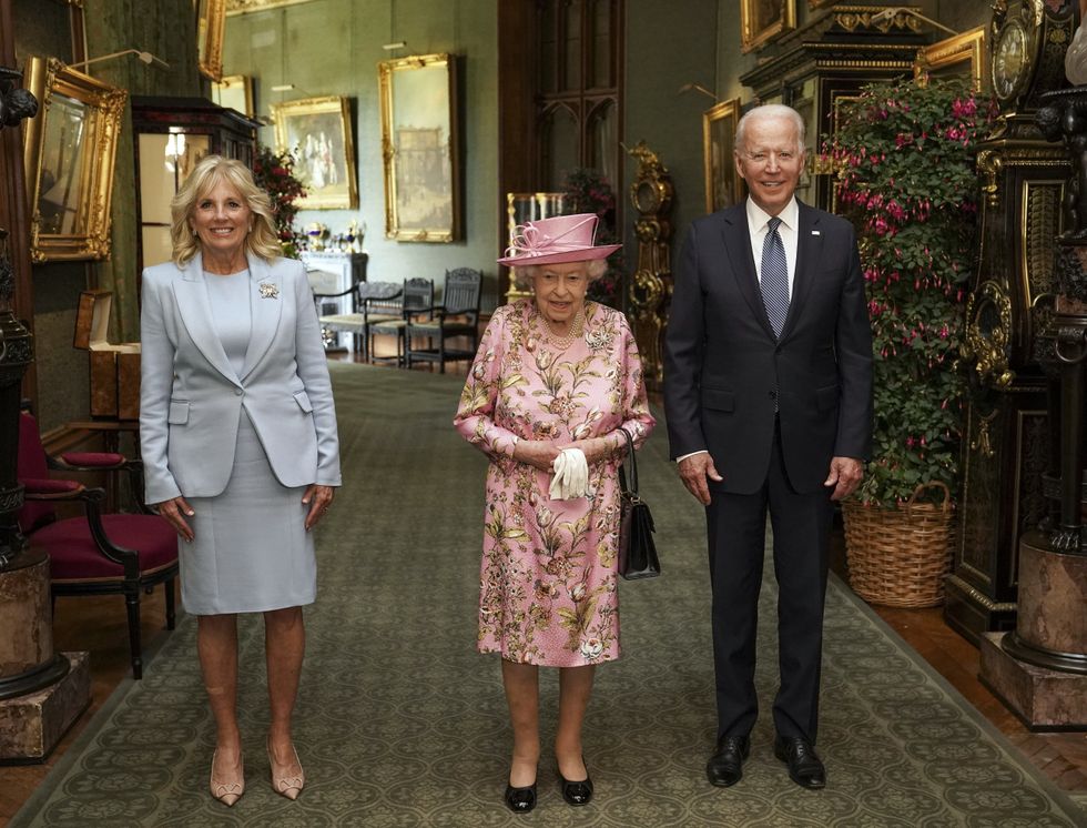 Queen Elizabeth II (centre) with US President Joe Biden and First Lady Jill Biden in the Grand Corridor during their visit to Windsor Castle in Berkshire.