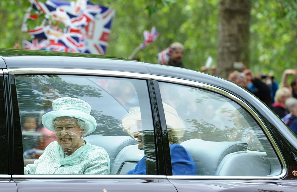 Queen Elizabeth II drives down the Mall with Diana Marion, The Lady Farnham, on her way to St Paul's Cathedral.