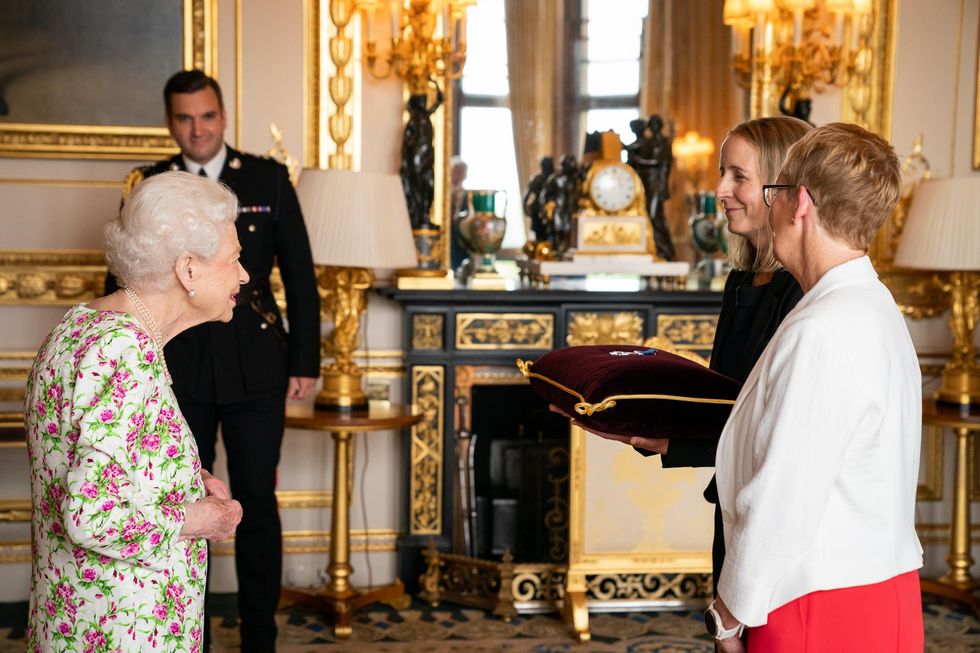 Queen Elizabeth II presenting the George Cross to representatives of the National Health Service, Ms Judith Paget CBE, Chief Executive NHS Wales and Dr Ami Jones MBE, Intensive Care Consultant, Aneurin Bevan University Health Board, during an Audience at Windsor Castle, Berkshire. Picture date: Tuesday July 12, 2022.