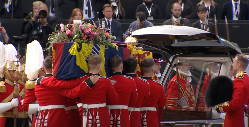 Queen Elizabeth II's coffin is placed in a hearse before making its way to Windsor Castle