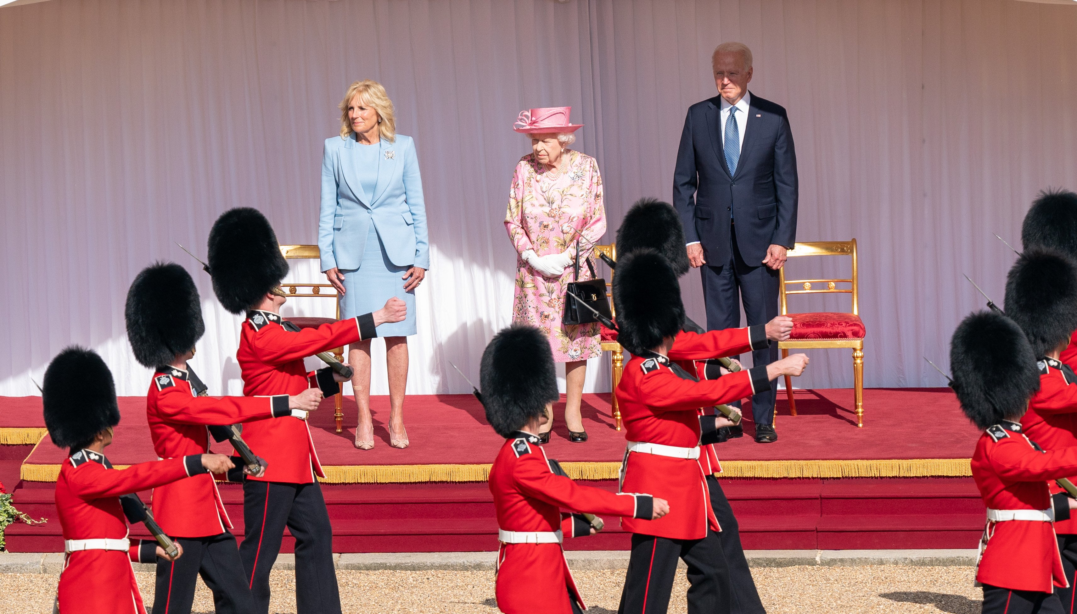 Queen Elizabeth II with US President Joe Biden and First Lady Jill Biden as the Queen's Company First Battalion Grenadier Guards pass by during a visit to Windsor Castle in Berkshire. Picture date: Sunday June 13, 2021.