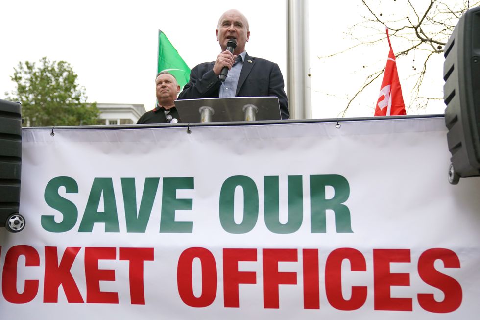 Rail, Maritime and Transport (RMT) union general secretary Mick Lynch speaking at a rally as Alex Gordon RMT President (left) listens outside King's Cross train station, in London
