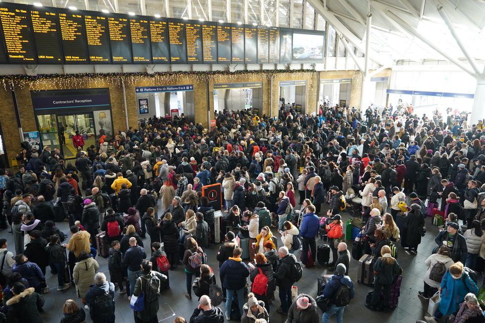 Rail strike misery: Passengers at London's King's Cross desperately try to catch a train earlier today