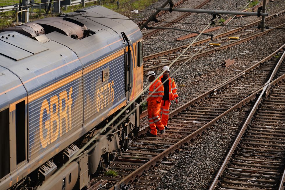 Railway workers at the scene of a freight train derailment in West Ealing, west London