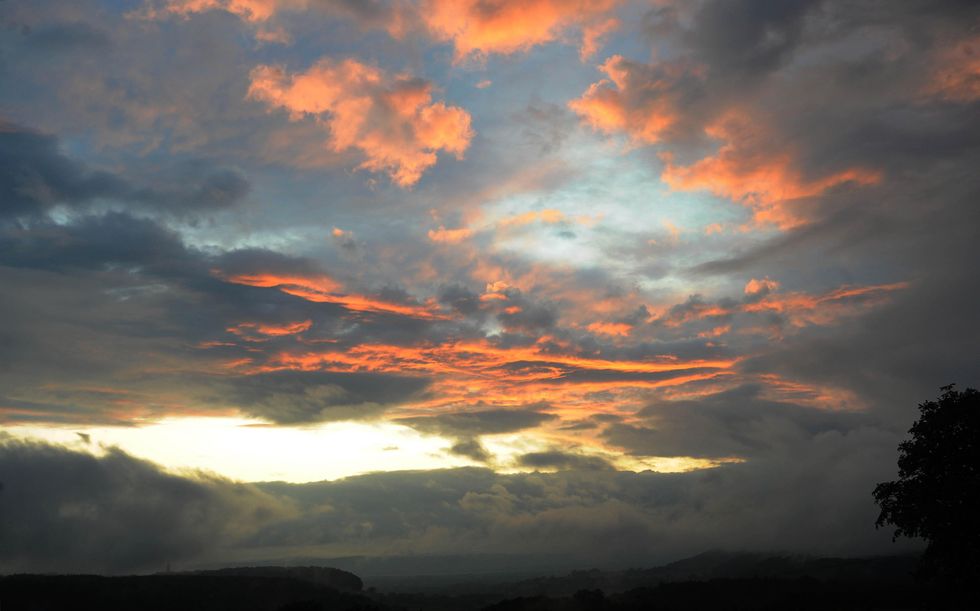 Rain stops and the clouds break giving a view of the sky at sunset over Gloucestershire. Forecasters warned today of the pitfalls of predicting the weather a long way in advance after the British summer has so far failed to live up to expectations.