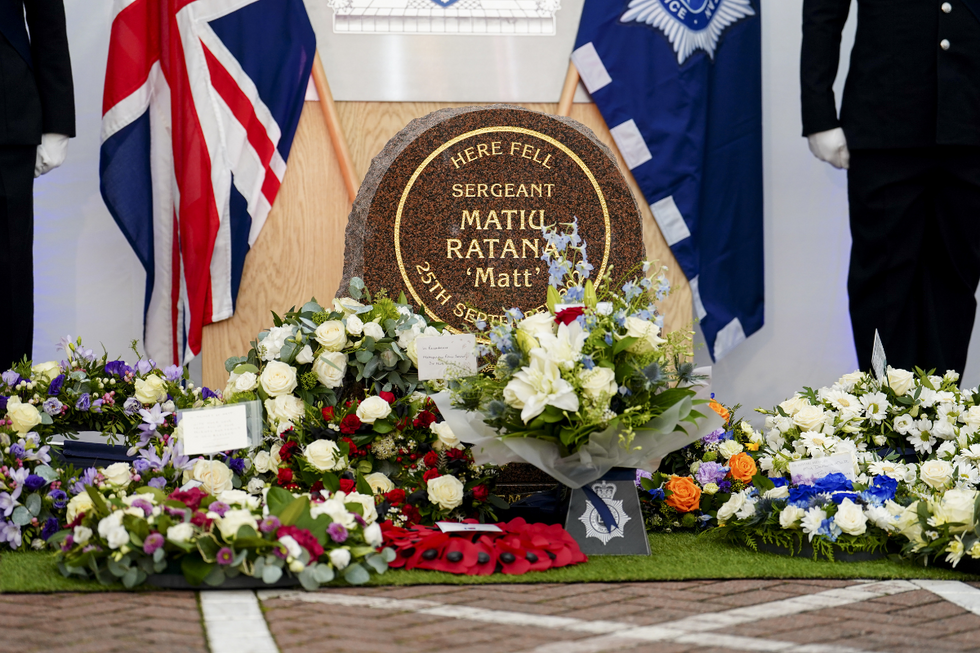 reaths are placed in front of the memorial stone