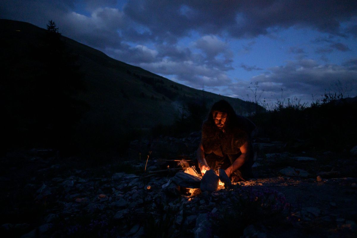 Recreation of a caveman lighting a fire