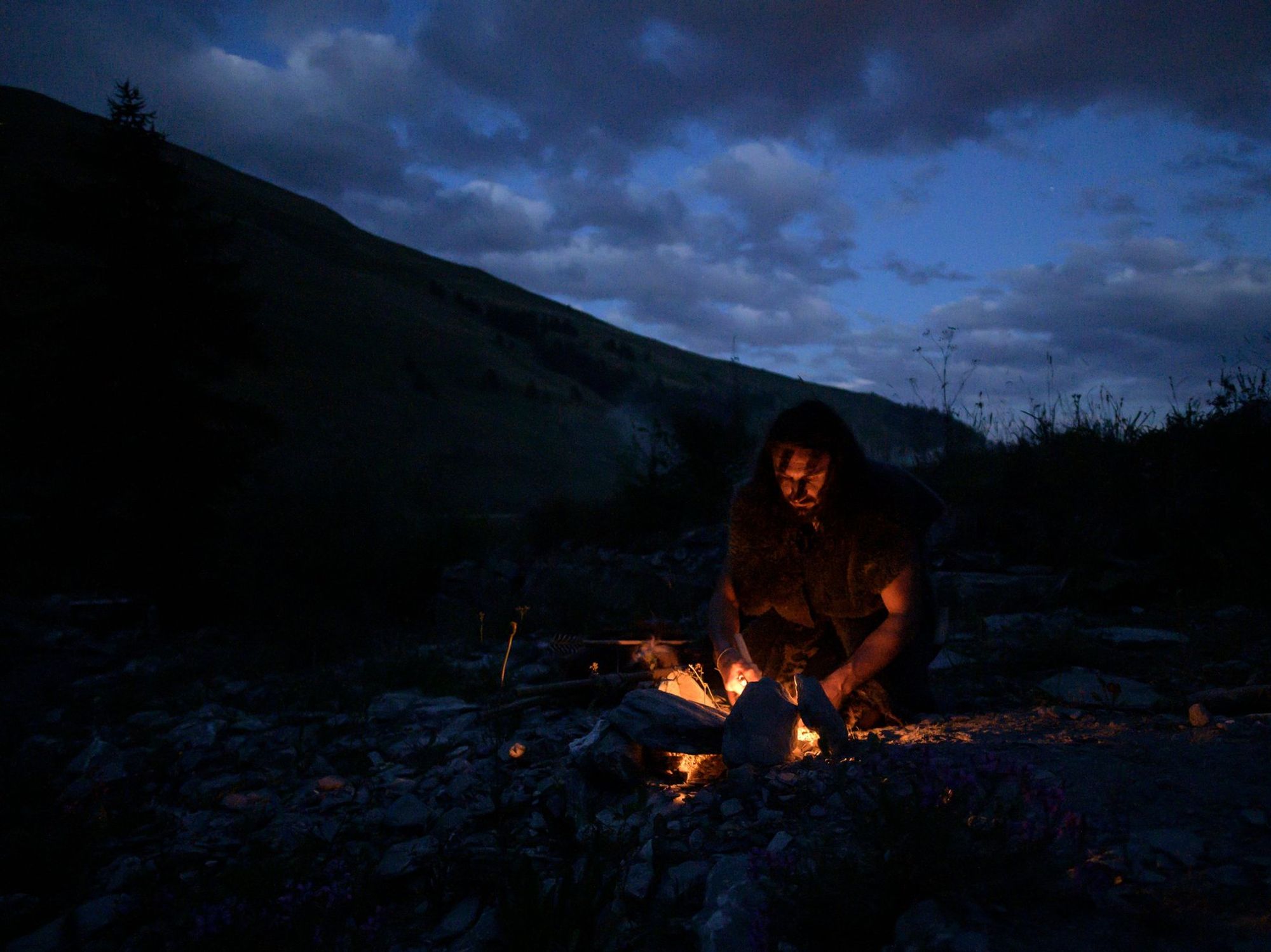 Recreation of a caveman lighting a fire