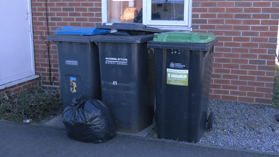 Recycling and waste bins outside a house