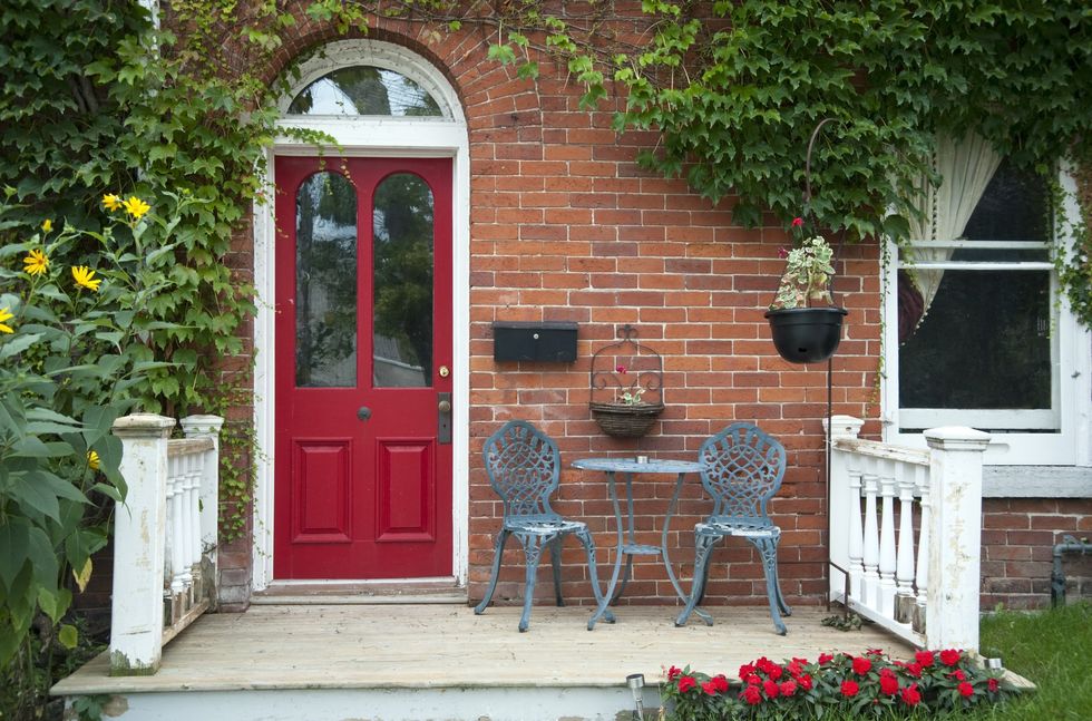 Red front door and beautiful garden