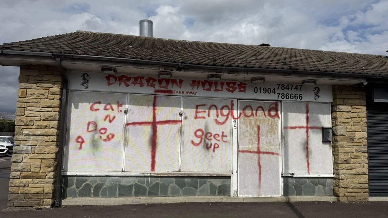 Red graffiti painted on Chinese takeaway
