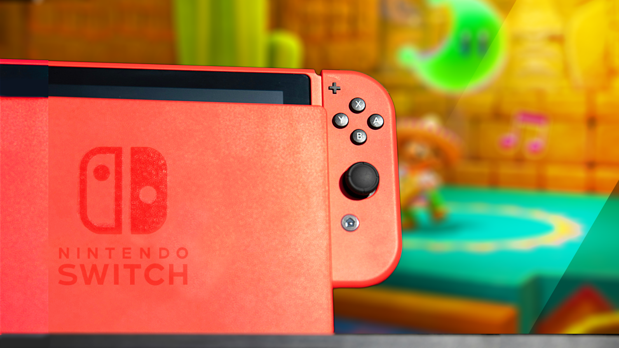 red nintendo switch console in the dock with a television showing mario odyssey in the background