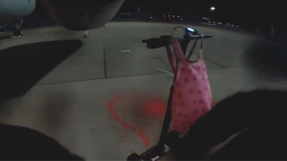 Red paint can be seen on the floor from the protesters