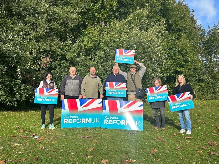 Reform UK campaigners hold signs alongside Lloyds and Corby Village candidate Lee Duffy