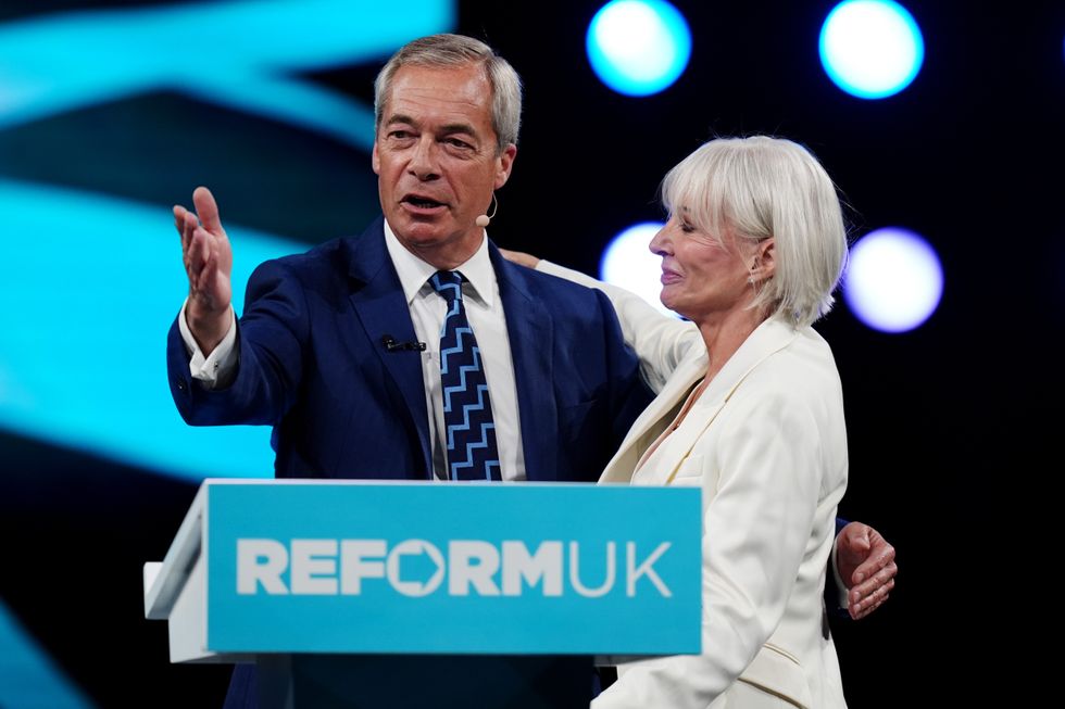 Reform UK leader Nigel Farage and former high-profile Conservative Nadine Dorries, who defected to Reform UK on the eve of its party conference, speak during the party's annual conference at the National Exhibition Centre in Birmingham