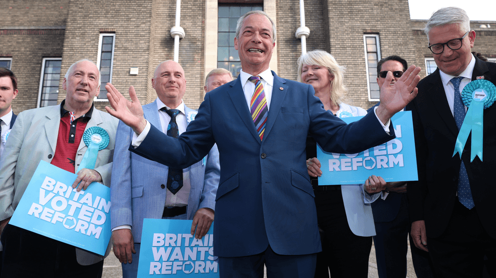 Reform UK leader Nigel Farage poses with winning councillors outside Havering Town Hall following the 2026 local election results on May 08, 2026 in Romford, England.