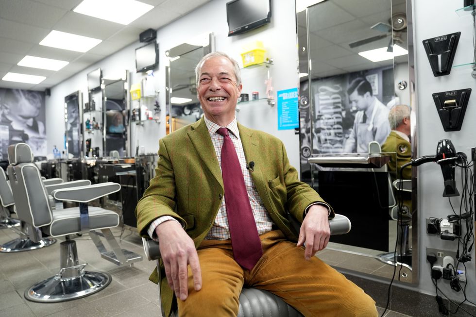 Reform UK leader Nigel Farage visits a barber's shop, during Reform UK's local election campaign launch for Cambridgeshire County Council