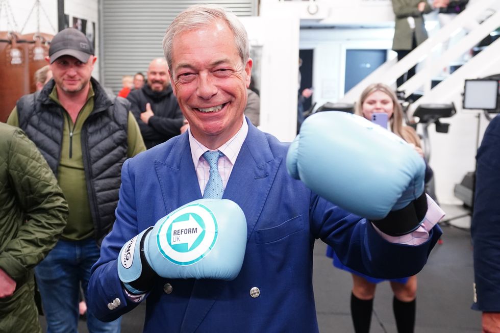 Reform UK leader Nigel Farage wearing boxing gloves at a boxing gym in Clacton, Essex