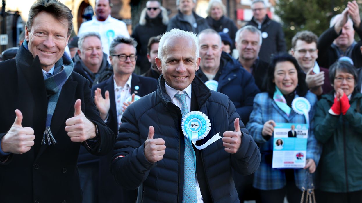 Reform UK leader Richard Tice and deputy Ben Habib give a thumbs up among supporters in the town centre on January 13, 2024 in Wellingborough