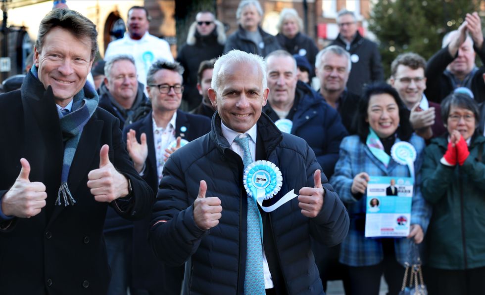 Reform UK leader Richard Tice and deputy Ben Habib give a thumbs up among supporters in the town centre on January 13, 2024 in Wellingborough