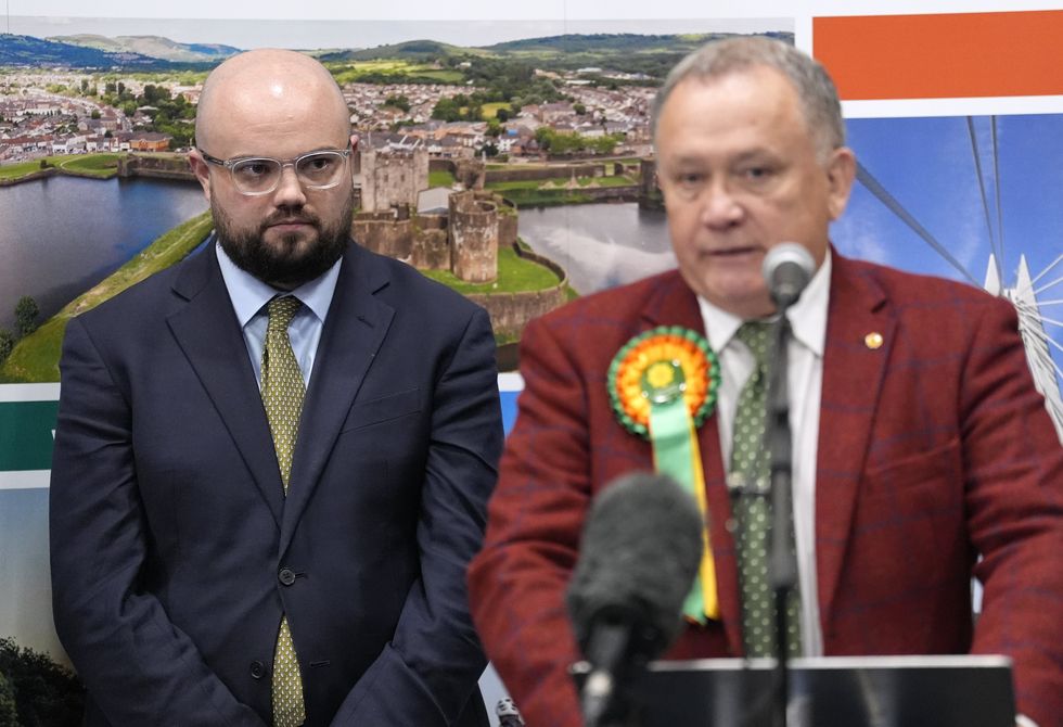 Reform UK's Llyr Powell (left) looks on as Plaid Cymru's Lindsay Whittle makes a speech after being declared winner for the Caerphilly Senedd by-election