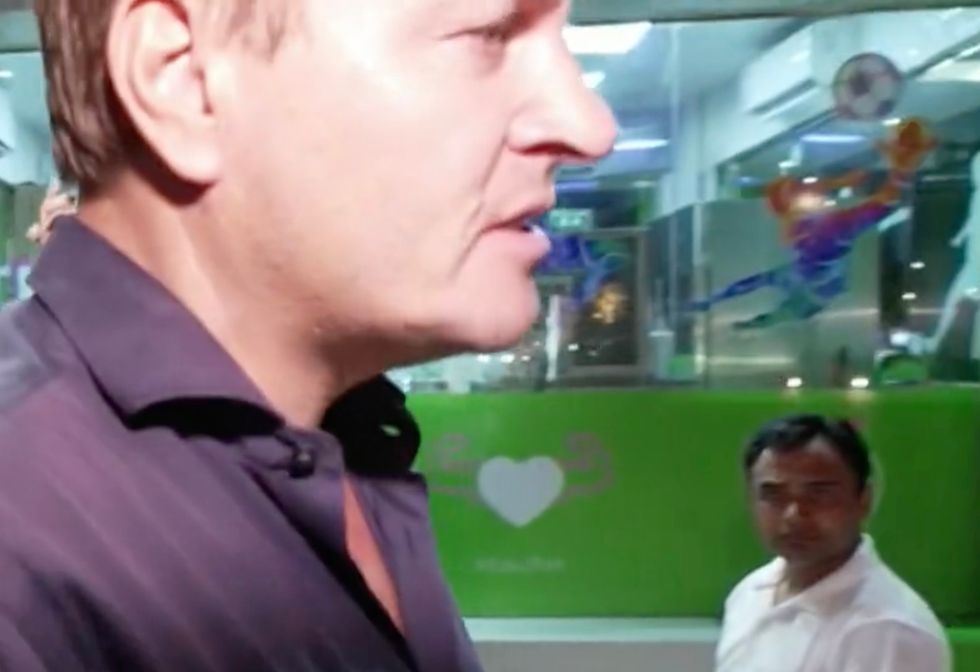 Reporter Rasmus Tantholdt is seen attempting to speak to the authorities