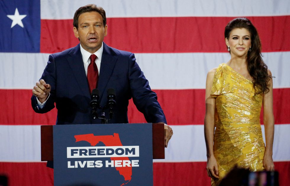 Republican Florida Governor Ron DeSantis speaks with his wife Casey DeSantis at his side during his 2022 U.S. midterm elections night party in Tampa, Florida, U.S., November 8, 2022. REUTERS/Marco Bello