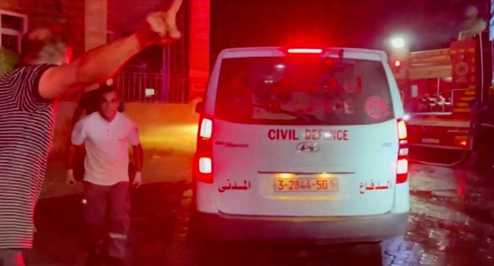 Rescue personnel work at scene At Al-Ahli Hospital