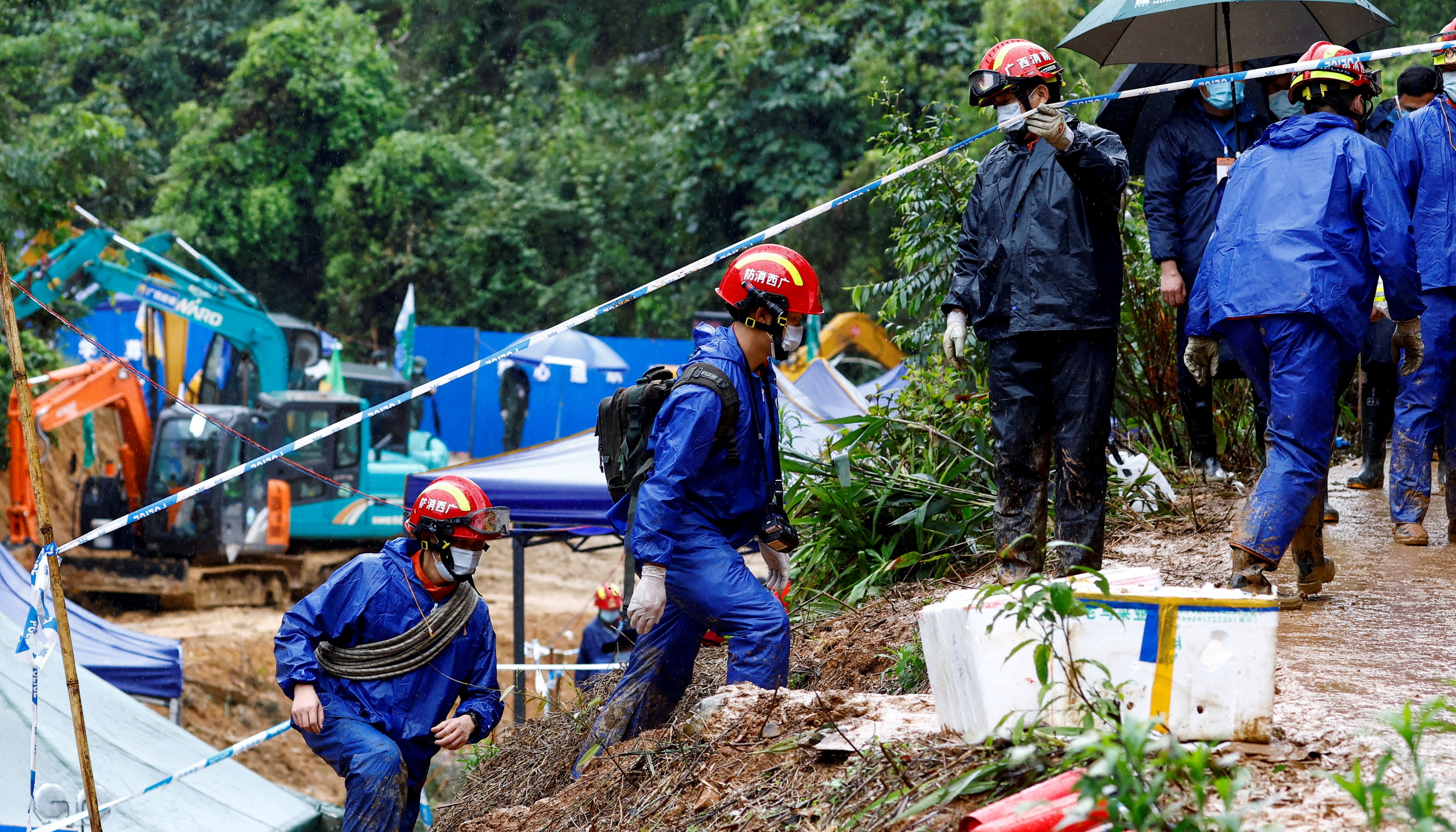 Rescue workers work at the site where a China Eastern Airlines Boeing 737-800 plane flying from Kunming to Guangzhou crashed