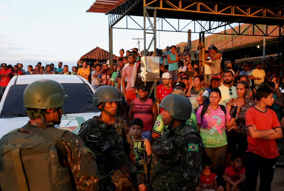 Residents gather at the port as officers conduct a search operation for British journalist Dom Phillips and indigenous expert Bruno Pereira, who went missing while reporting in a remote and lawless part of the Amazon rainforest, near the border with Peru, in Atalaia do Norte, Amazonas state, Brazil.