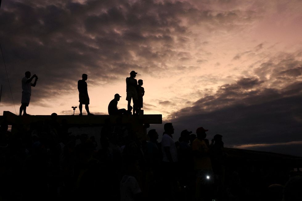 Residents gather at the port as officers conduct a search operation for British journalist Dom Phillips and indigenous expert Bruno Pereira, who went missing while reporting in a remote and lawless part of the Amazon rainforest, near the border with Peru, in Atalaia do Norte, Amazonas state, Brazil.