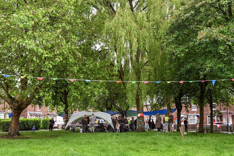 Residents shelter under marquees during a Platinum Jubilee party on Chester Avenue in Dukinfield
