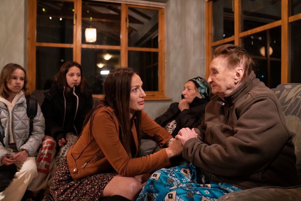 RETRANSMITTED WITH CORRECT SPELLING OF REND PLATINGS Ludmila Starkova, 90, (right) who fled Kharkiv in the Ukraine with her family following the Russian invasion, talks to Rend Platings in her new home in Caldecote near Cambridge. The family of ten, who range in age from Alikhan, aged 10, to 90-year-old great grandmother Ludmila, began their journeys on March 1, and have been helped by Rend Platings to find a new home in the UK for them and their two dogs Mikki and Florie. Picture date: Tuesday March 22, 2022.