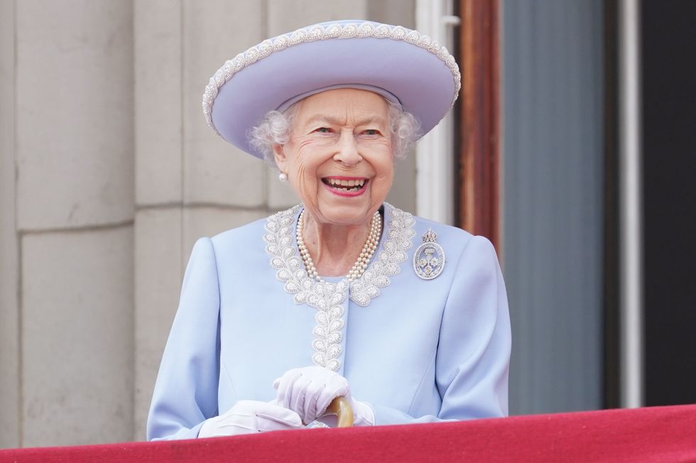 RETRANSMITTING AMENDING LOCATION FROM HORSE GUARDS TO BUCKINGHAM PALACE Queen Elizabeth II watching the Royal Procession from the balcony at Buckingham Palace following the Trooping the Colour ceremony in central London, as the Queen celebrates her official birthday, on day one of the Platinum Jubilee celebrations. Picture date: Thursday June 2, 2022.