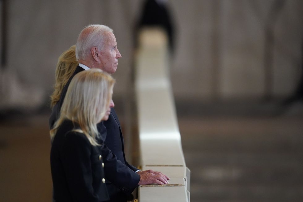 RETRANSMITTING WITH ADDITIONAL NAME US President Joe Biden and US Ambassador to the UK, Jane Hartley, view the coffin of Queen Elizabeth II, lying in state on the catafalque in Westminster Hall, at the Palace of Westminster, London, ahead of her funeral on Monday. Picture date: Sunday September 18, 2022.
