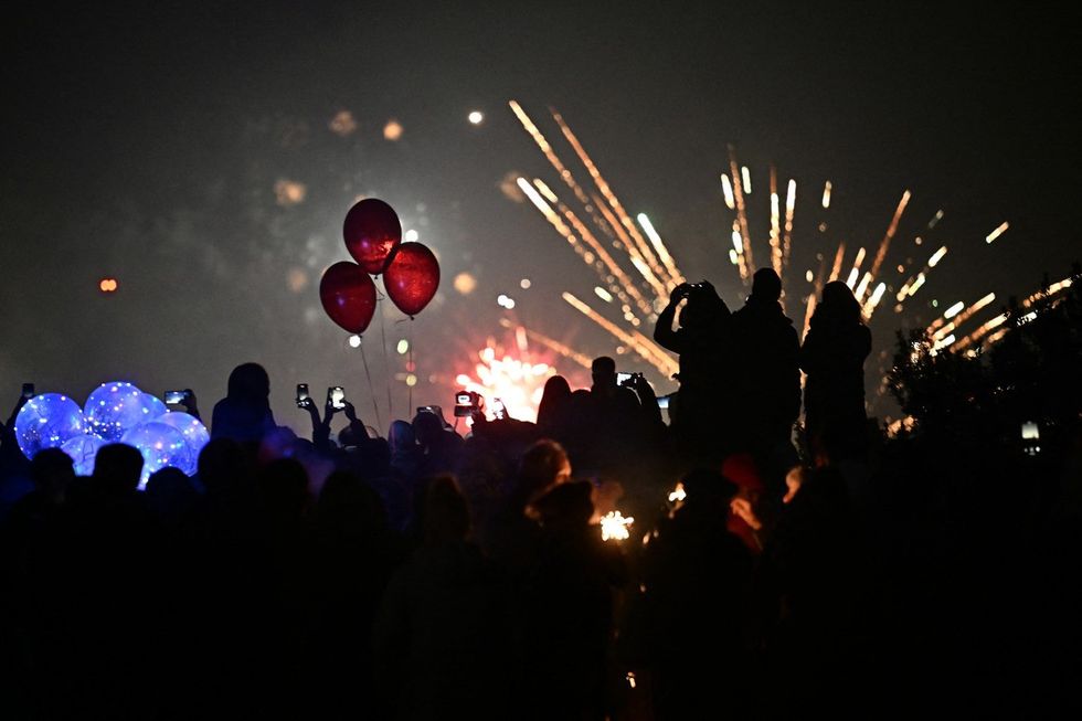Revellers watch fireworks in Pincio in Rome