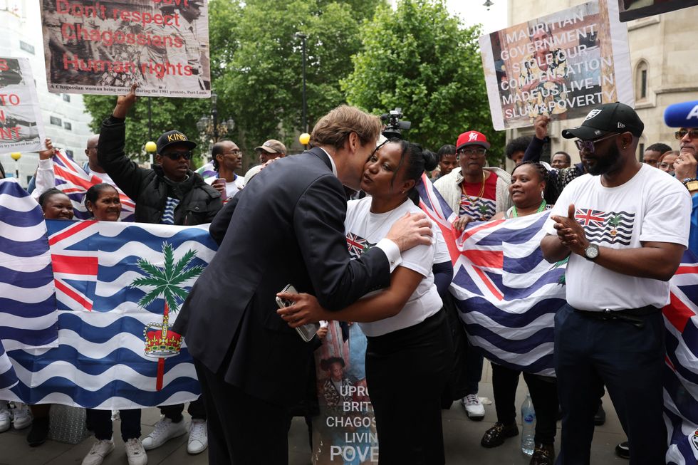 Richard Tice embraces a member of the British Chagossian community