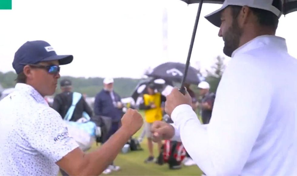 Rickie Fowler gave Scottie Scheffler a fist bump at the range