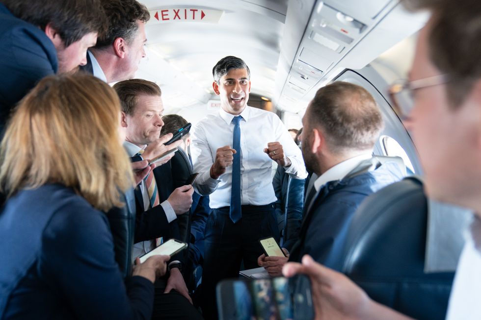 rime Minister Rishi Sunak talks to journalists on his plane as he travels from Northern Ireland to Birmingham during a day of campaigning