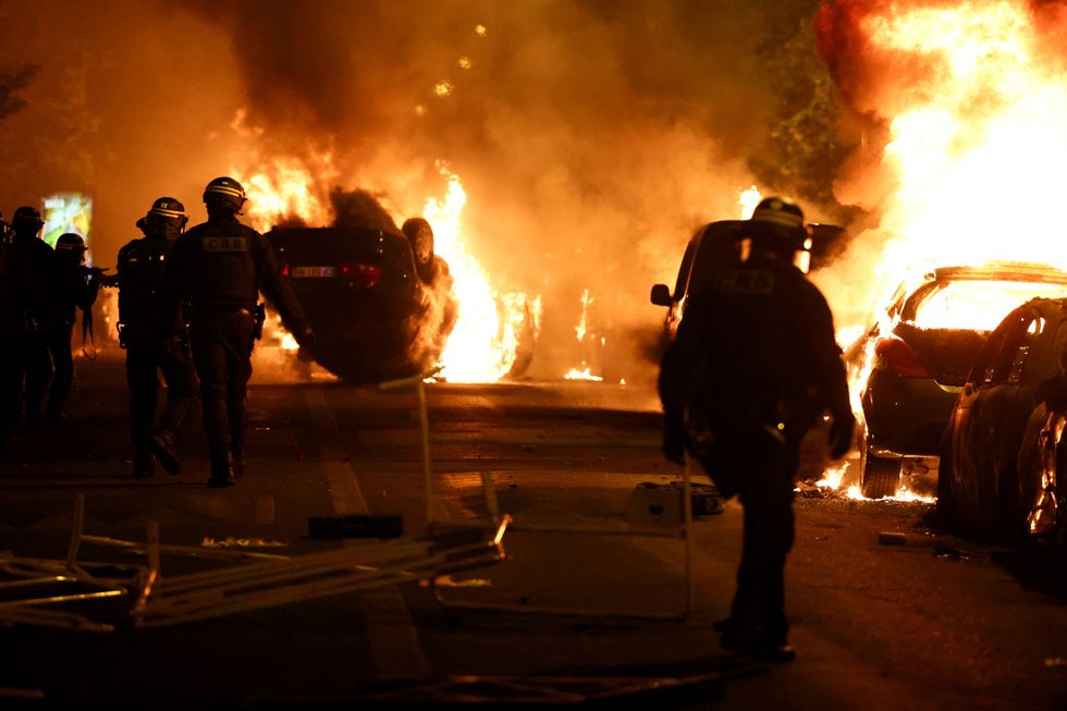 riot police face flames