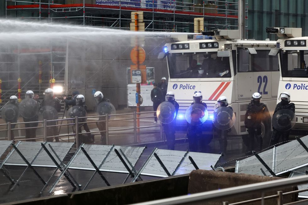 Riot police fired a water cannon to put out flames