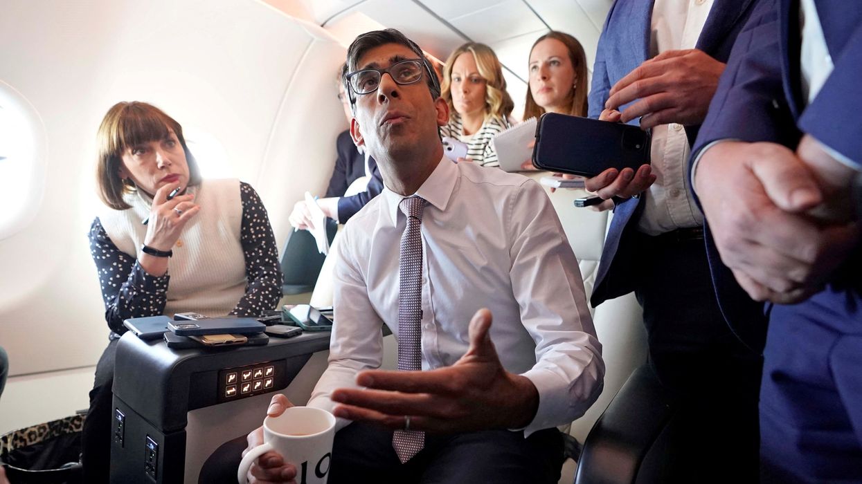 Rishi Sunak addresses reporters on the plane