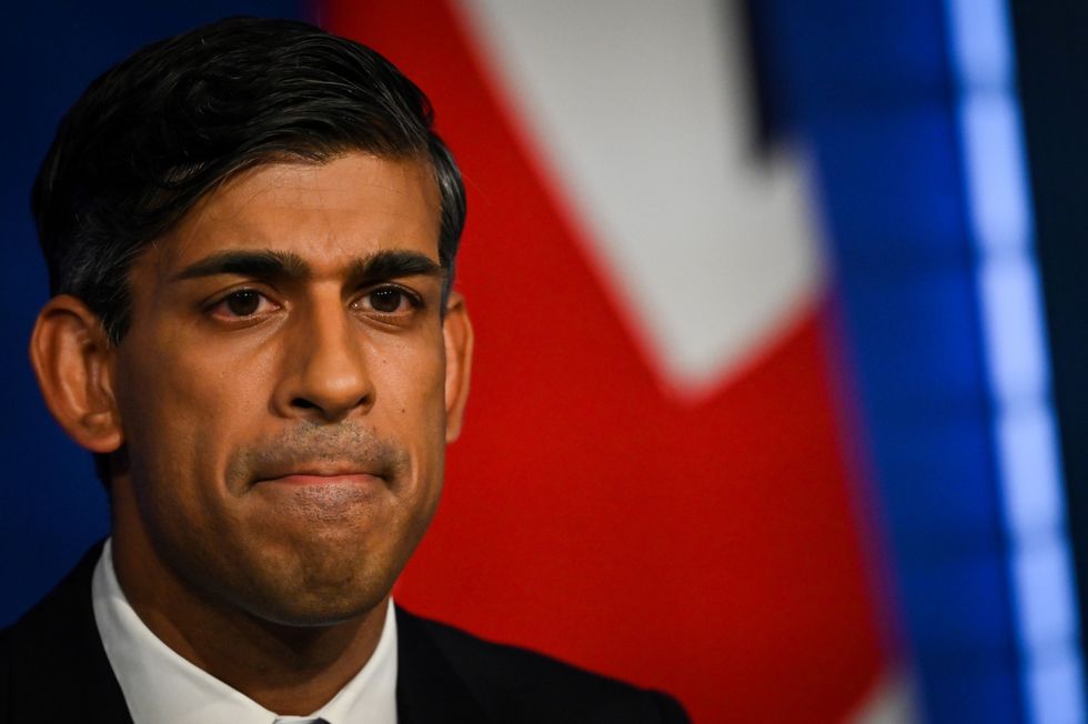 Rishi Sunak reacts while a holding press conference on net zero policy change