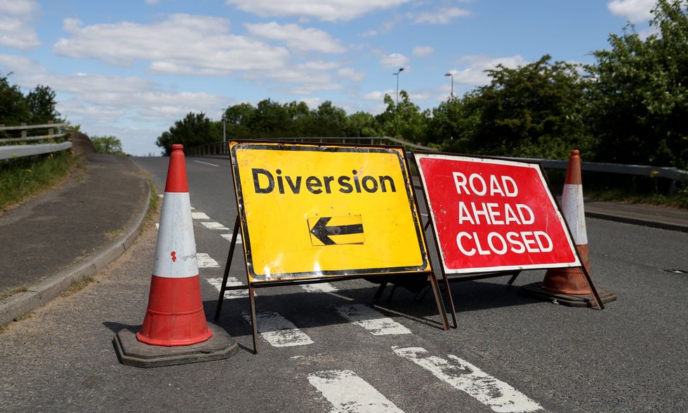 Road ahead closed sign and a diversion sign