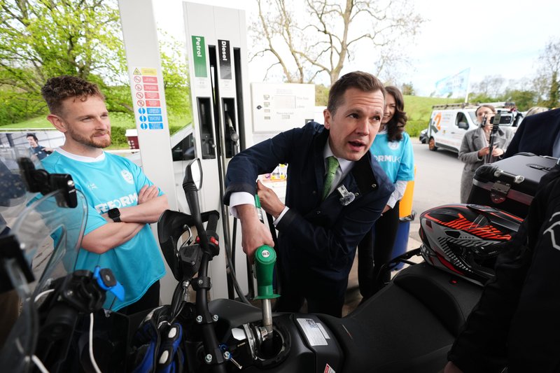 Robert Jenrick MP filling up a fuel tank in Nottingham