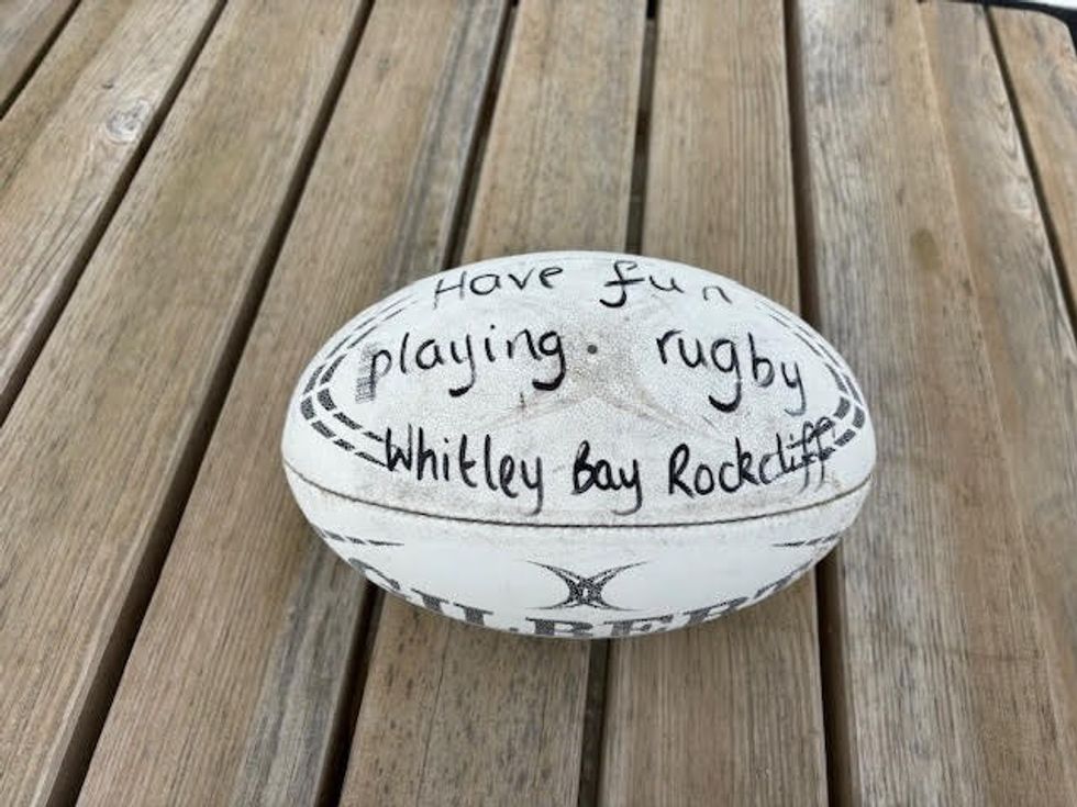 Rockcliff Rugby Club wrote on the ball