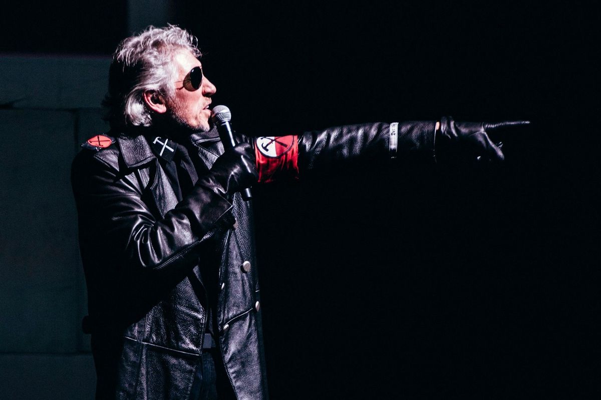 Roger Waters dressed in SS-style uniform points