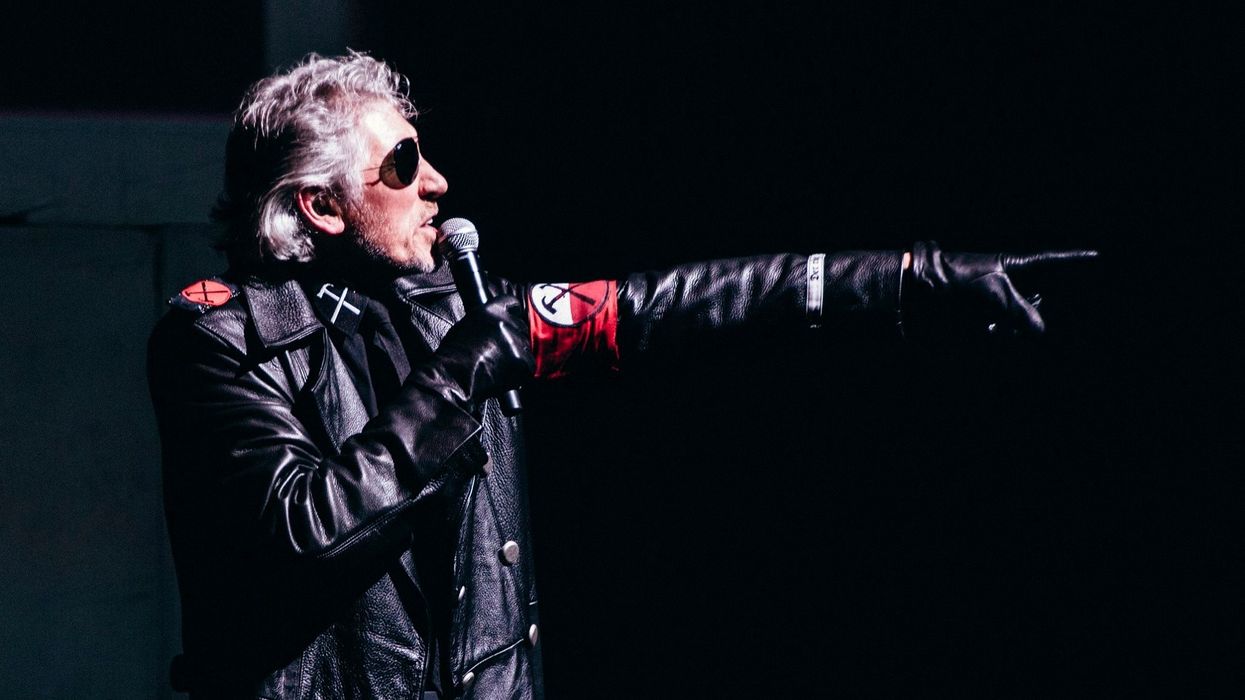 Roger Waters dressed in SS-style uniform points