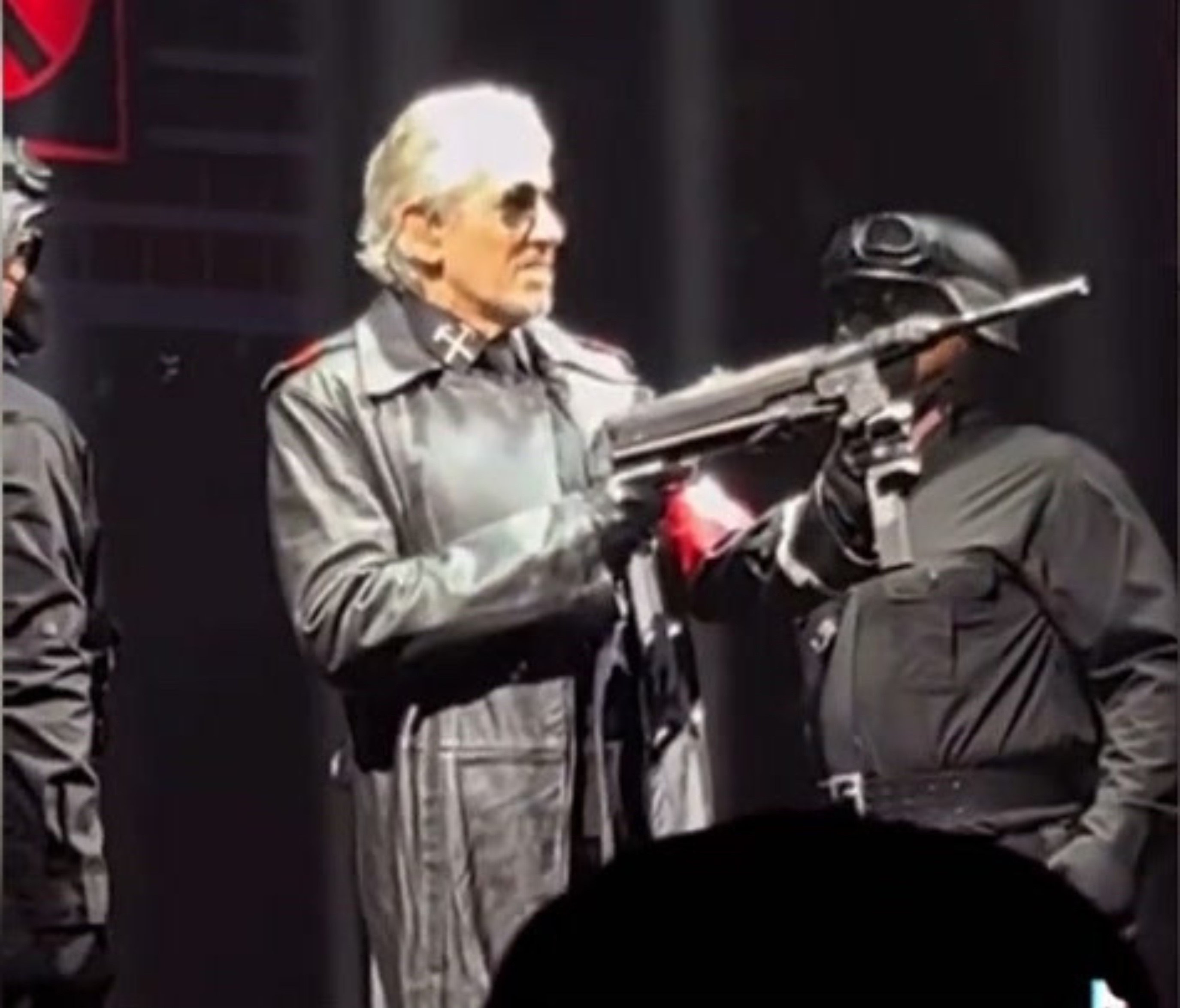 Roger Waters holding gun dressed in SS-style uniform
